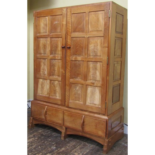 1482 - A fine quality Cotswold school fitted wardrobe in pale English walnut, the paneled frame enclosed by... 