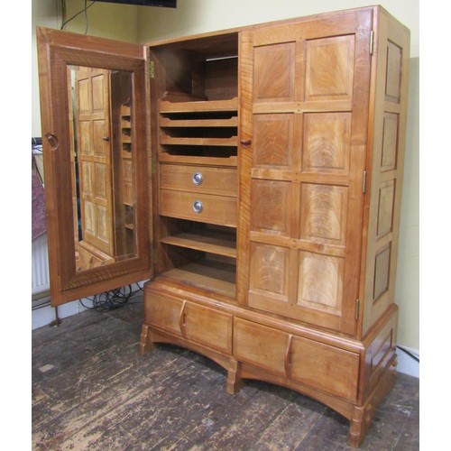 1482 - A fine quality Cotswold school fitted wardrobe in pale English walnut, the paneled frame enclosed by... 