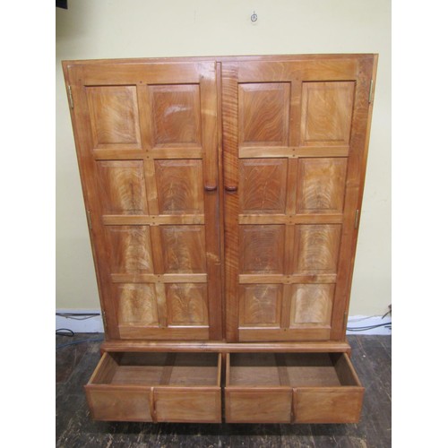 1482 - A fine quality Cotswold school fitted wardrobe in pale English walnut, the paneled frame enclosed by... 