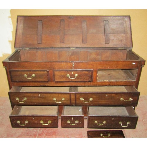 1538 - A Georgian oak north country mule chest with rising lid over an arrangement of five real and three d... 