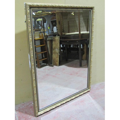 1553 - A large decorative wall mirror with bevelled edge mirror plate, 135cm high x 105cm wide