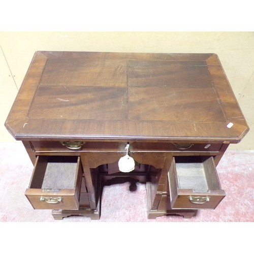 1555 - A Georgian style mahogany and oak lined kneehole desk or eight drawers and central cupboard, 77cm hi... 