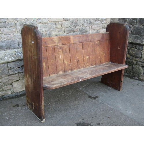 1058 - A stained pine church pew with chamfered ends, 100cm high x 135cm