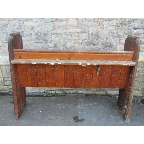 1058 - A stained pine church pew with chamfered ends, 100cm high x 135cm