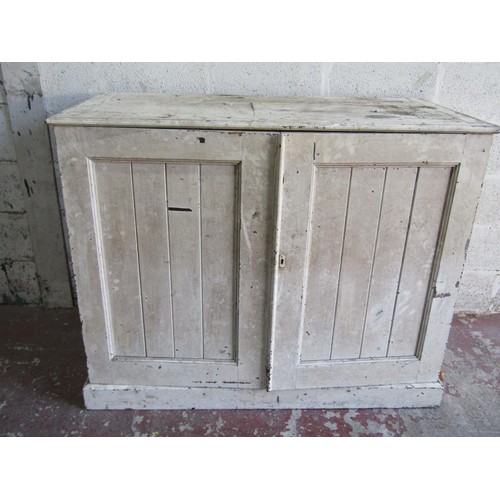 1554 - An antique rustic painted farmhouse pine cupboard with twin panelled hinged doors enclosing a vacant... 