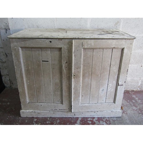 1554 - An antique rustic painted farmhouse pine cupboard with twin panelled hinged doors enclosing a vacant... 