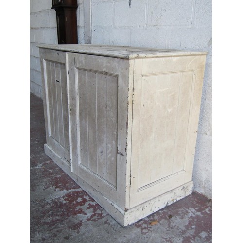 1554 - An antique rustic painted farmhouse pine cupboard with twin panelled hinged doors enclosing a vacant... 