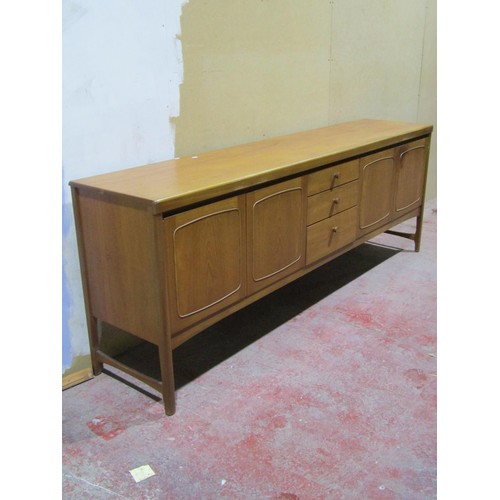 1544 - A mid 20th century Nathan teakwood sideboard, fitted with three central graduating drawers flanked b... 