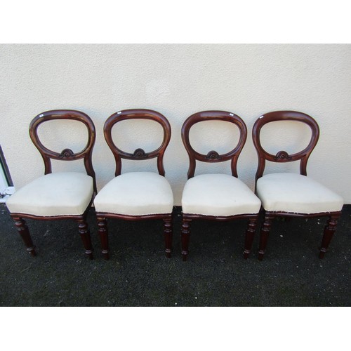 1495 - Four Victorian mahogany dining chairs, with carved rails and fixed seats over fluted tapering legs.