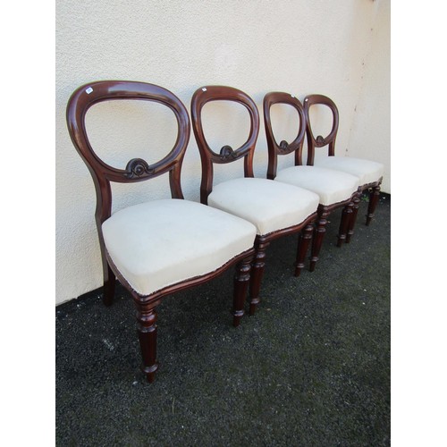 1495 - Four Victorian mahogany dining chairs, with carved rails and fixed seats over fluted tapering legs.