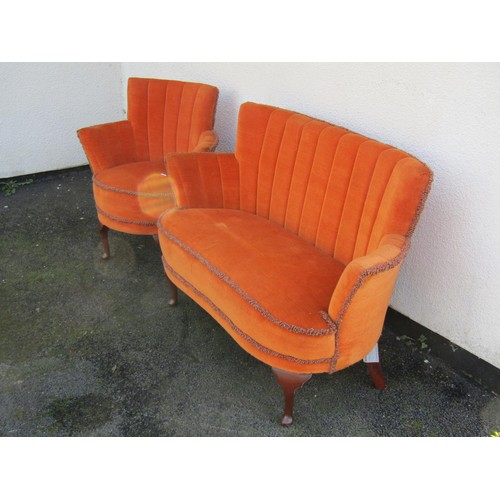 1505 - A mid century small upholstered wing settee and matching chair, in the Art Deco style, with shaped b... 