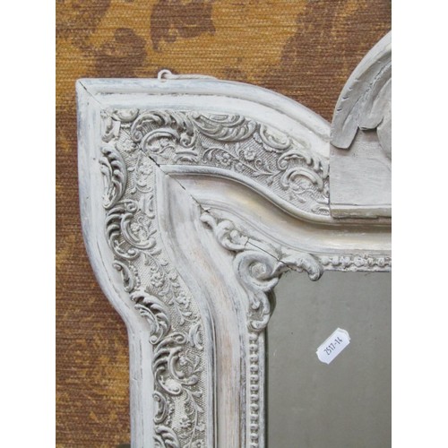 1368 - An antique Breton wall mirror with rectangular plate within a shaped carved and moulded frame with p... 