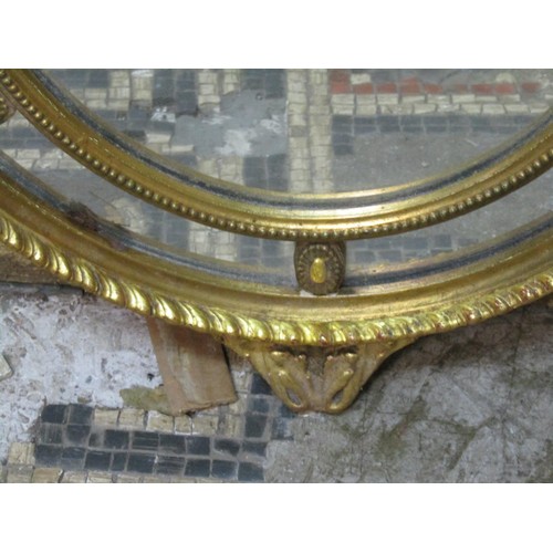 1363 - An Edwardian oval gilt framed wall mirror in the Georgian style with flaming urn, trailing harebell ... 