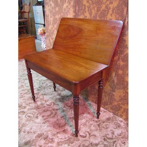 1376 - A Victorian mahogany fold over tea table raised on turned and octagonal tapered supports, 74 cm high... 