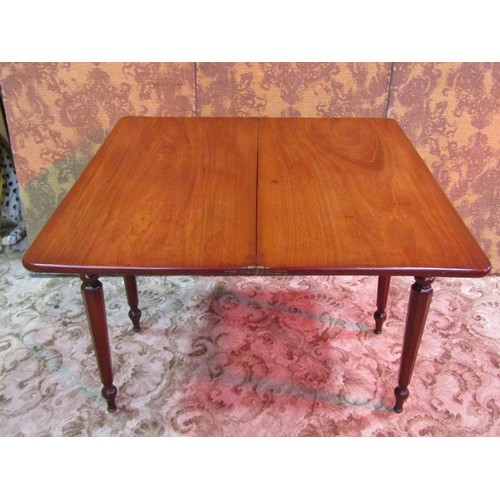 1376 - A Victorian mahogany fold over tea table raised on turned and octagonal tapered supports, 74 cm high... 