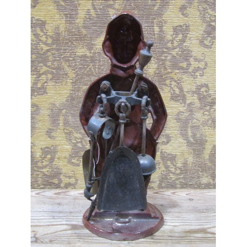 1083 - A novelty cast iron and enamelled companion set in the form of a Dutch boy, 39 cm high