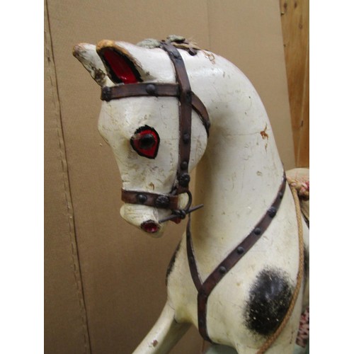 1397 - An Edwardian timber rocking horse in original condition raised on a central bar, 115cm long x 90cm h... 