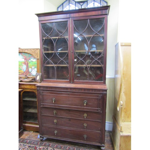 1439 - A Georgian mahogany secretaire bookcase, the lower section enclosed by three long drawers, the secre... 