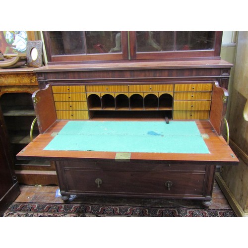 1439 - A Georgian mahogany secretaire bookcase, the lower section enclosed by three long drawers, the secre... 