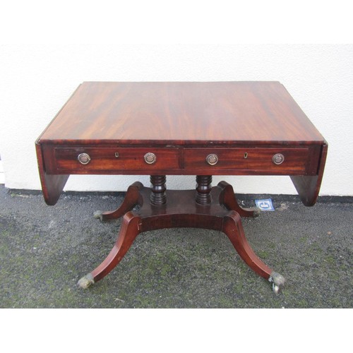 1499 - A 19th century mahogany sofa table fitted with two real and two dummy frieze drawers over a platform... 