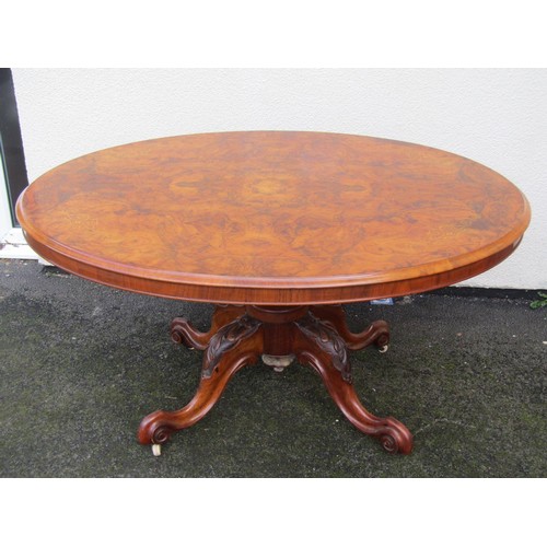 1498 - A Victorian quart veneered burr walnut loo table with strung inlaid borders raised on carved support... 