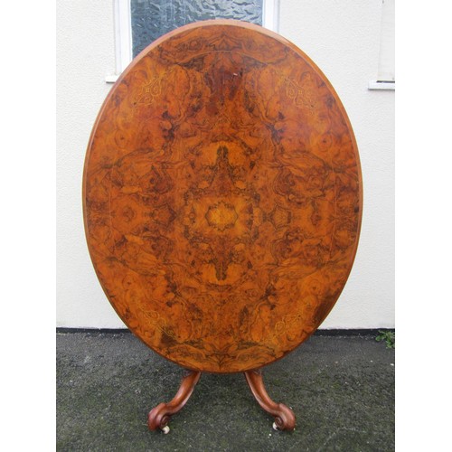 1498 - A Victorian quart veneered burr walnut loo table with strung inlaid borders raised on carved support... 