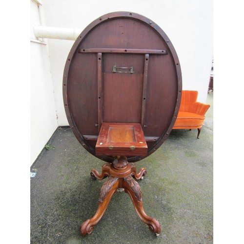 1498 - A Victorian quart veneered burr walnut loo table with strung inlaid borders raised on carved support... 