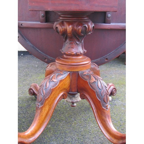 1498 - A Victorian quart veneered burr walnut loo table with strung inlaid borders raised on carved support... 