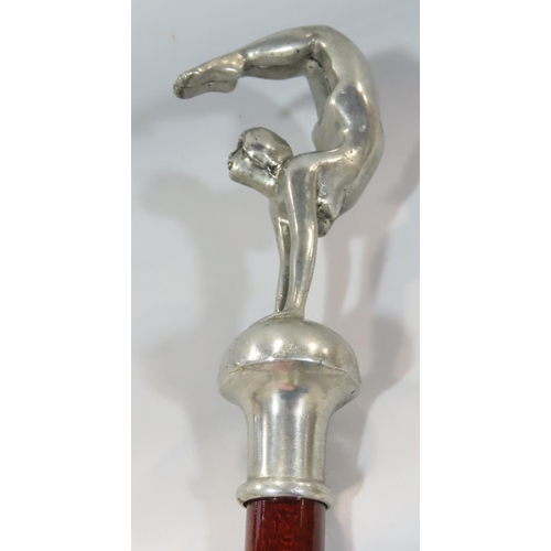 540 - An Art Deco walking stick with a gymnastic naked female handle, and another stick with floral carved... 