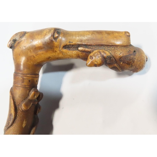 540 - An Art Deco walking stick with a gymnastic naked female handle, and another stick with floral carved... 