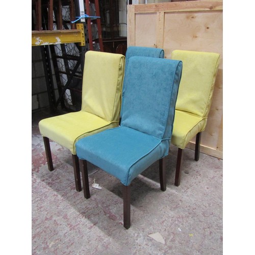 1517 - A set of four contemporary dining chairs, with stitched leather seats, beneath loose yellow and blue... 