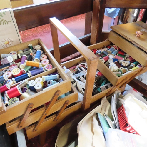 453 - A quantity of sewing equipment, some contained in a concertina six tier wooden sewing box, together ... 