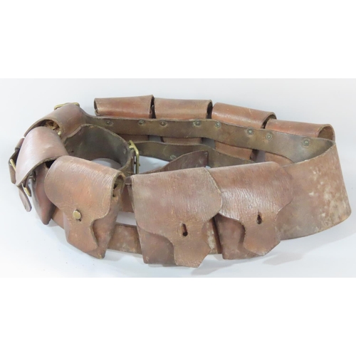 454 - An early 20th century leather nine-pouch ammunition bandolier, together with a mahogany writing slop... 