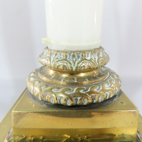 473 - An opaque white glass column candlestick with a stepped brass square base and brass sconce, adapted ... 