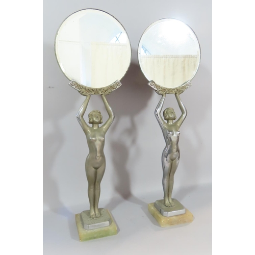 478 - A pair of Art Deco dressing table mirrors held aloft by nude female figures. 52cm high.