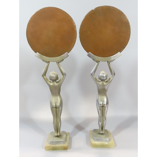 478 - A pair of Art Deco dressing table mirrors held aloft by nude female figures. 52cm high.