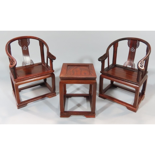 481 - A 20th century Chinese boxed carved hardwood group, miniature pair of horseshoe backed chairs,  asso... 