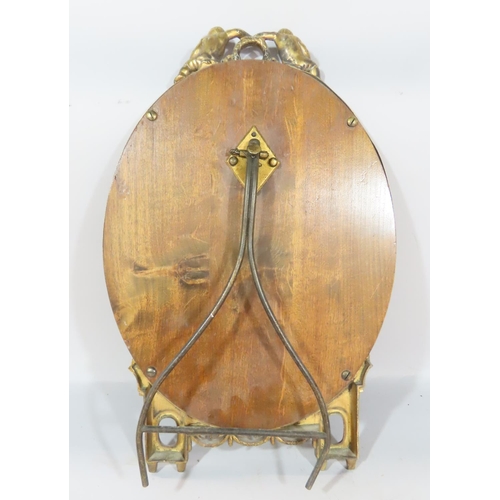 494 - A French late 19th century oval bevelled dressing table mirror, with a brass acanthus leaf frame top... 