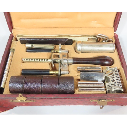 497 - A patent Kampfe Bros. razor set with accessories all contained in distressed red padded leather box.