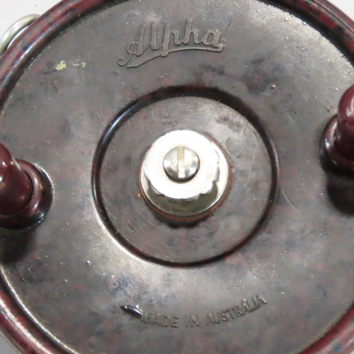 498 - An Australian Alpha Bakelite fishing reel, 13cm diam.