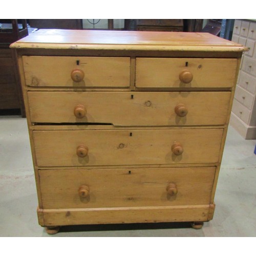 1199 - A Victorian stripped pine country made chest of two short and three long drawers raised on bun feet,... 