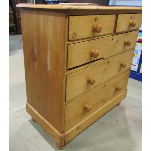 1199 - A Victorian stripped pine country made chest of two short and three long drawers raised on bun feet,... 