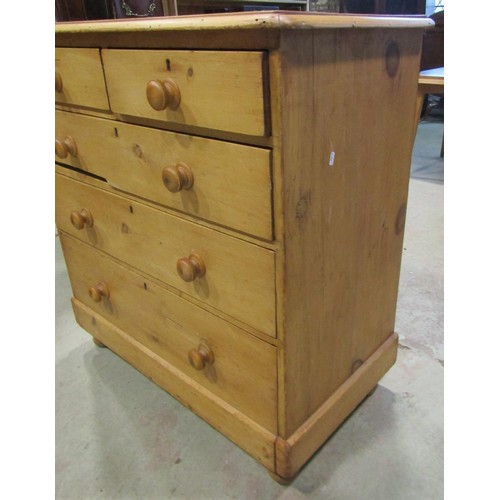 1199 - A Victorian stripped pine country made chest of two short and three long drawers raised on bun feet,... 