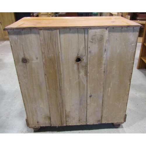 1199 - A Victorian stripped pine country made chest of two short and three long drawers raised on bun feet,... 