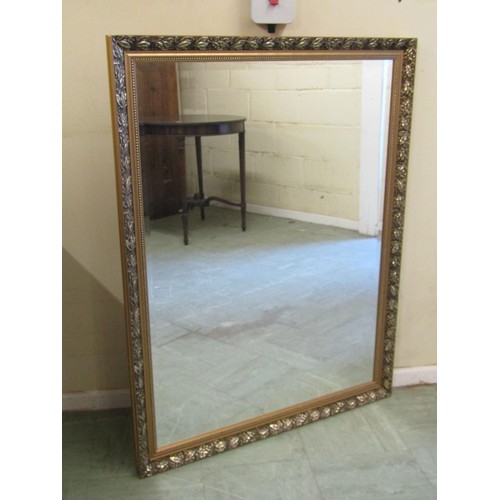 1566 - A large gilt-framed wall mirror with bevelled plate, beaded and foliate moulded borders, 112 x 87cm.