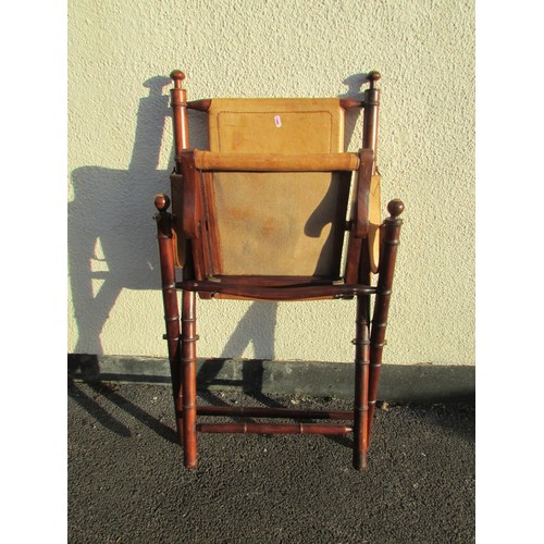 1575 - A reproduction strap work campaign chair with leather panels together with a small  octagonal drum t... 