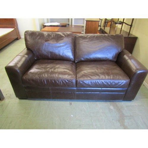 1579 - A good quality contemporary stitched brown leather two-seater sofa bed, 200cm wide.