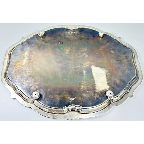 223A - A George V silver tray with shaped and raised borders set on four ball and claw supports, 46cm max, ... 