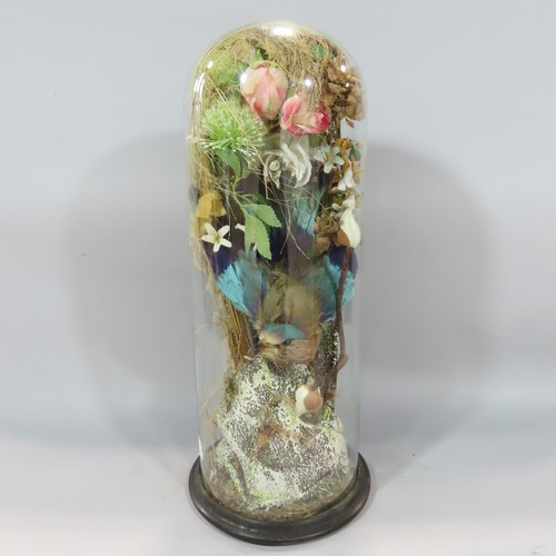 562 - A Victorian domed display case with an Indian Roller Bird amongst an artificial flower arrangement .