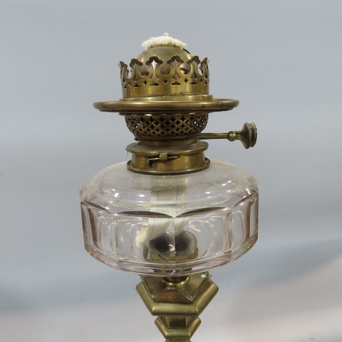 570 - A Gothic Victorian brass candlestick Hinks oil lamp with an etched glass shade, 75cm high.